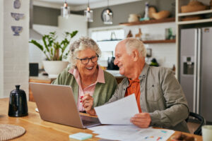 A senior couple sitting in the kitchen putting together an estate plan.