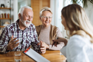 A senior couple creating a will with an attorney.