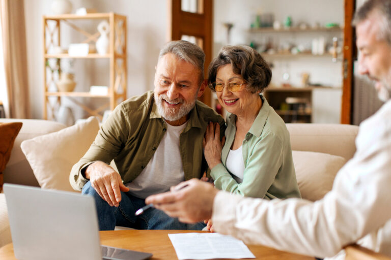 Senior couple having a meeting with an attorney happily