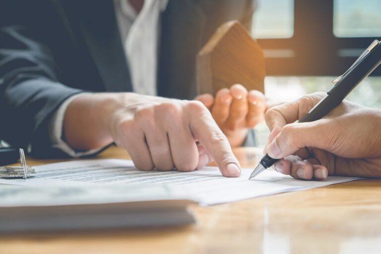 An estate planning attorney showing a client how they can avoid the Kansas probate process.